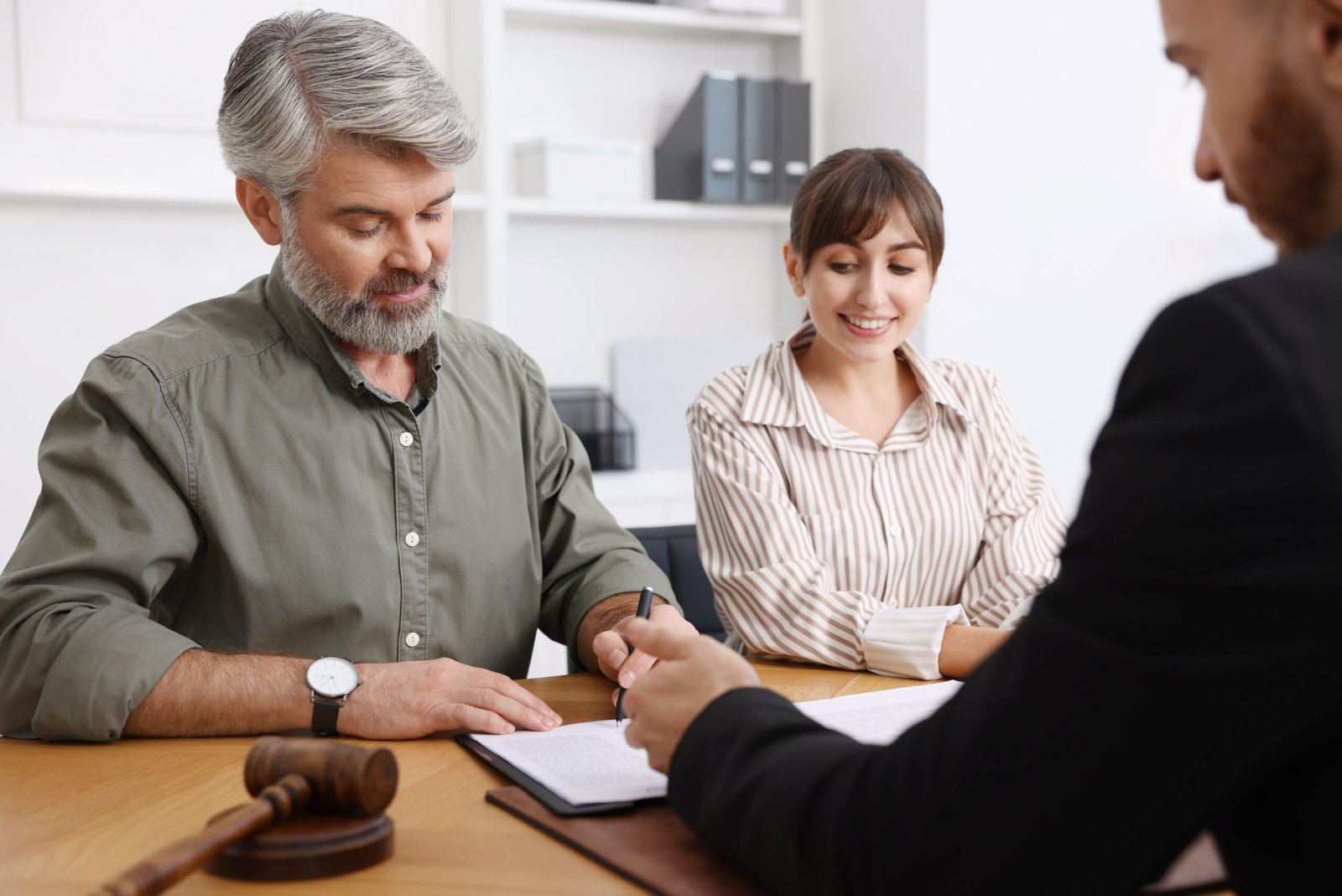 Clients Signing Papers with Attorney